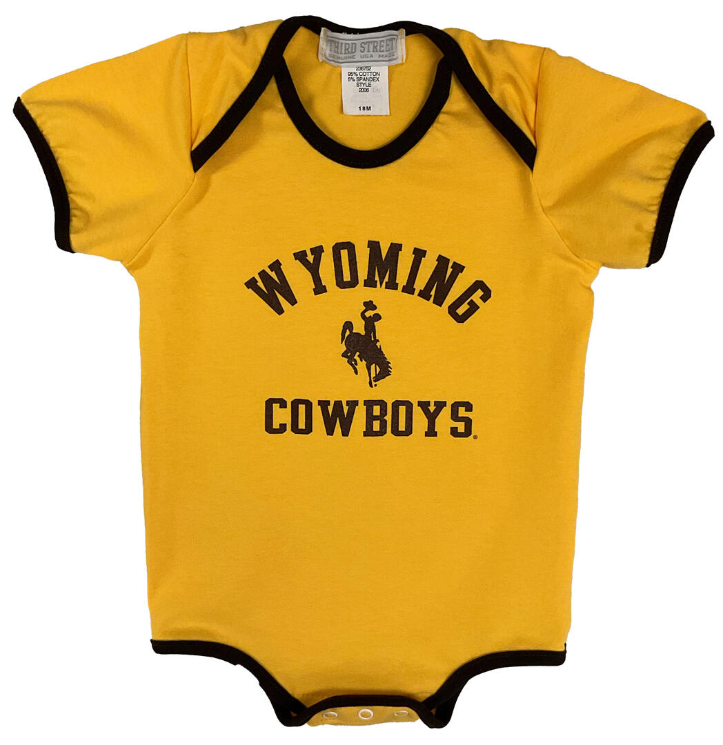 gold short sleeve onesie with brown trim, design center chest, all brown design. Arced wyoming with bucking horse under and cowboys at bottom