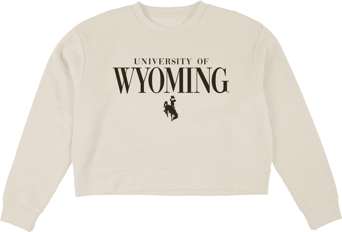 womens ivory crewneck sweatshirt with brown design center chest. design is univeristy of wyoming with wyoming lettering emphasized bigger and a bucking horse centered below.