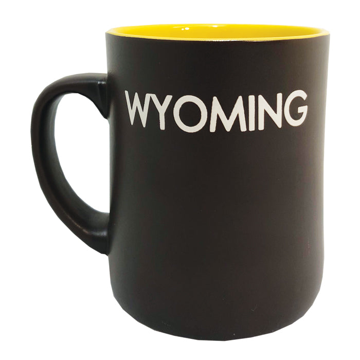 brown mug with gold colored interior. Large white bucking horse printed on one side and word Wyoming printed on the other