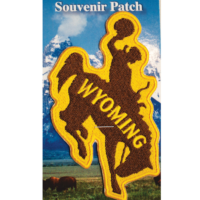 bucking horse shaped iron on patch. patch is brown with gold outline, with word Wyoming inside the bucking horse in gold