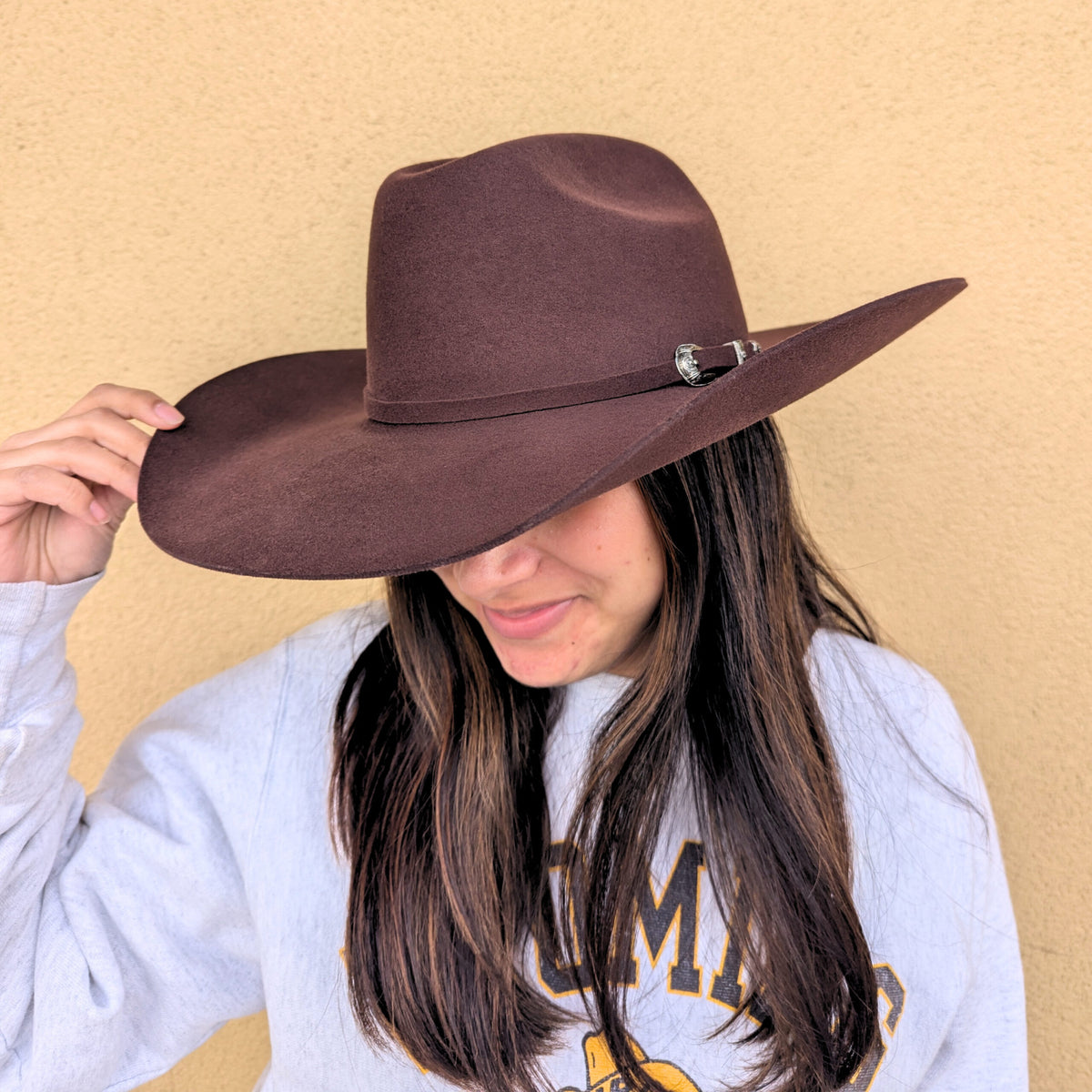 employee wearing the brown grand entry cowboys hat