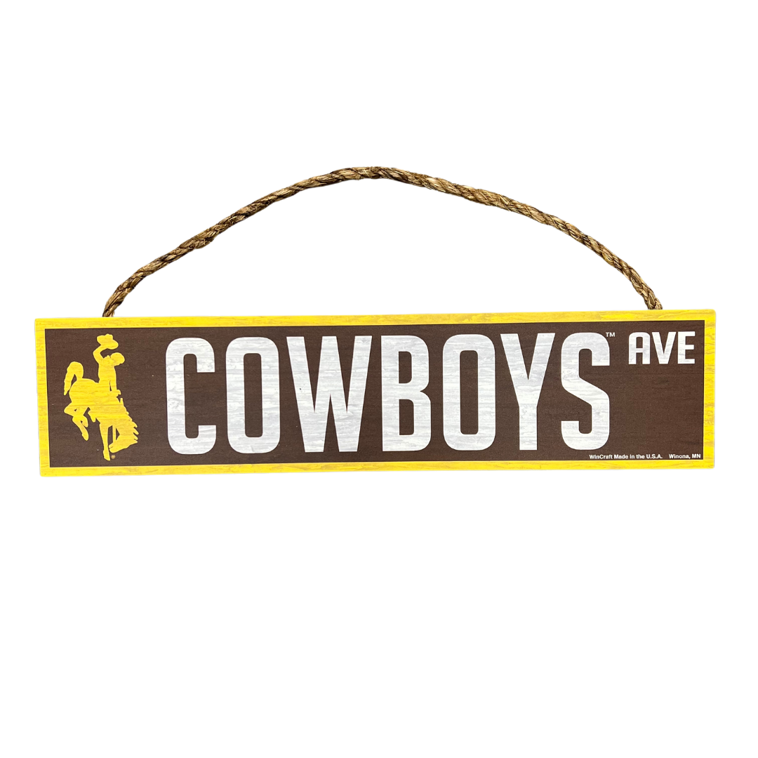 Brown wood sign with rope hanging detail, design is gold bucking horse, white word cowboys ave, gold outline around sign