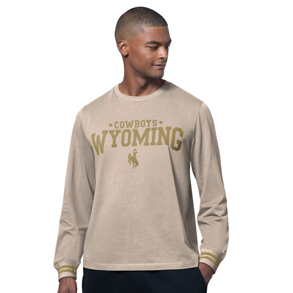 tan long sleeve with cowboys above wyoming lettering and bucking horse below. has two stripes on wrists on sleeves.