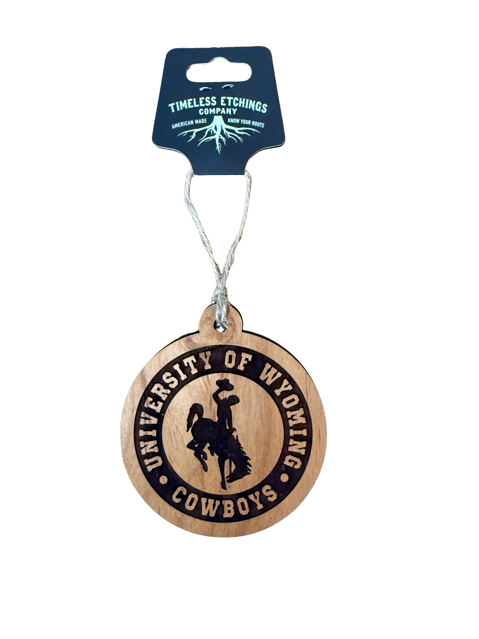 Wooden ornament with 'University of Wyoming Cowboys' text and logo, hanging from a card labeled 'Timeless Etchings Company'.
