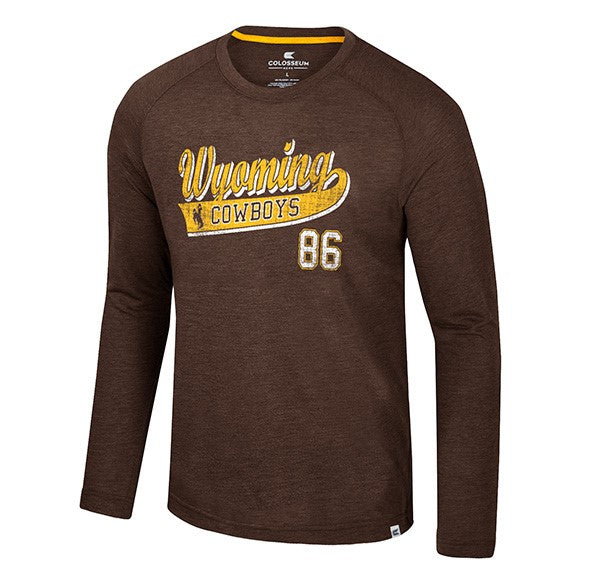 brown long sleeve with design center chest. design is wyoming lettering in gold with white shadow. has pennant below with cowboys lettering in brown with brown bucking horse. white 86 at bottom