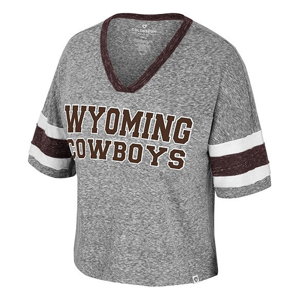 grey women's v-neck cropped tee shirt. has jersey type stripes on sleeve in white and brown. design on center chest is brown wyoming cowboys lettering stacked with white outline.