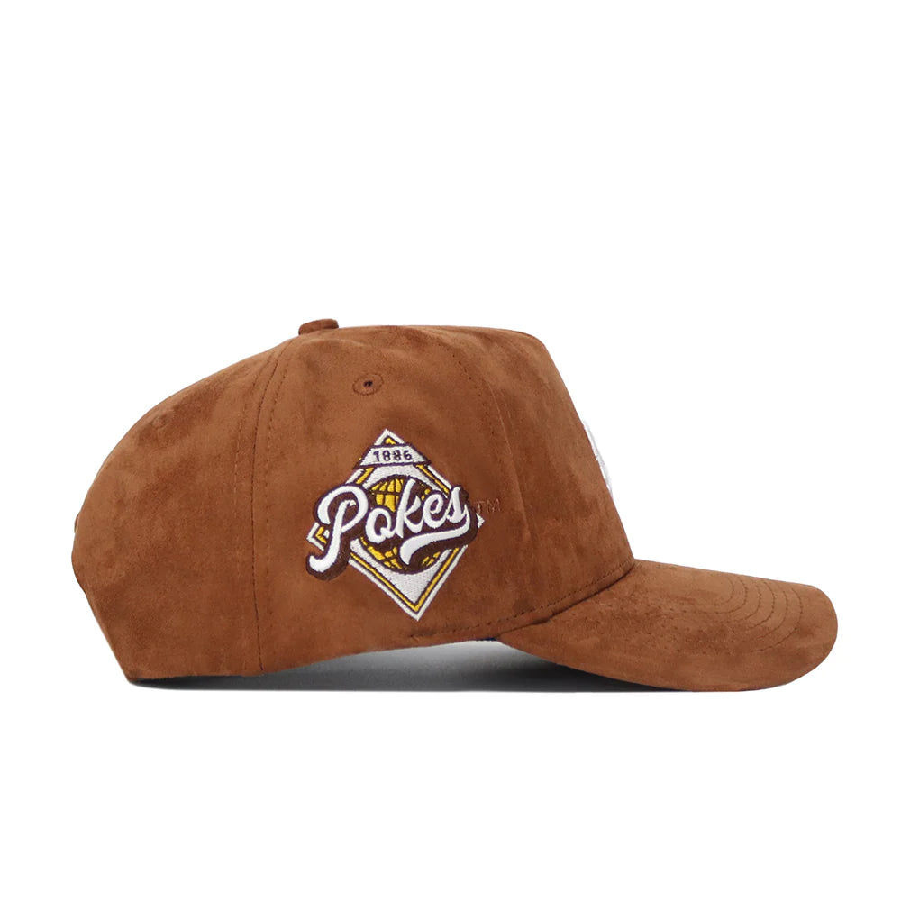 corduroy brown hat with white bucking horse embroidered on front panel. has pokes diamond graphic on right side of hat in white brown and gold
