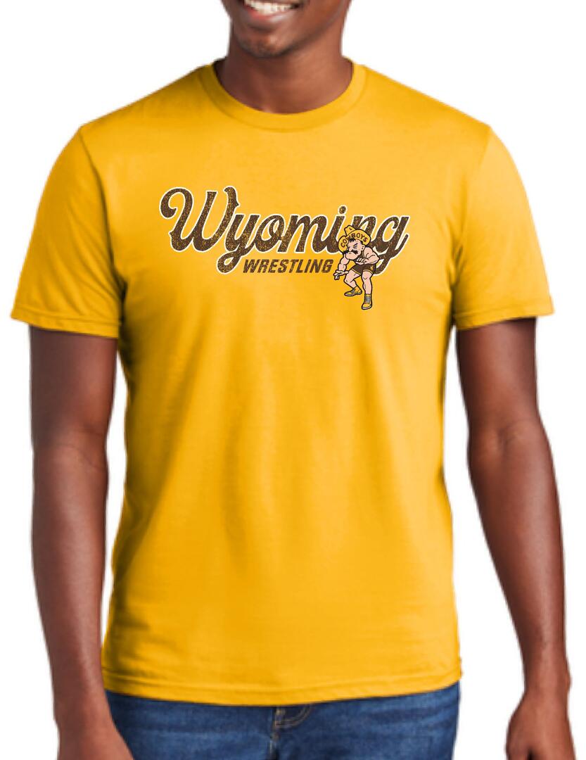 Gold short sleeve tee with script wyoming in brown with gold outline. Wrestling under in brown with pistol pete to the left wrestling