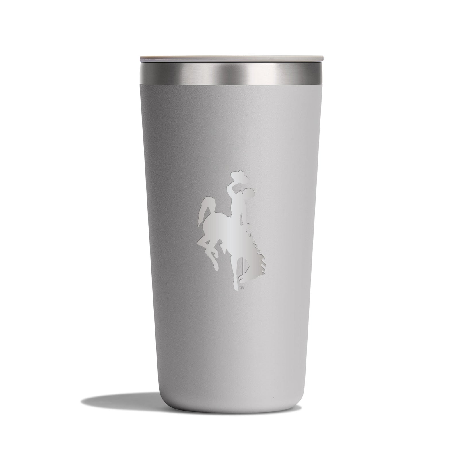 grey tumbler with silver top. has an etched bucking horse logo on side all pictured on a white backround.