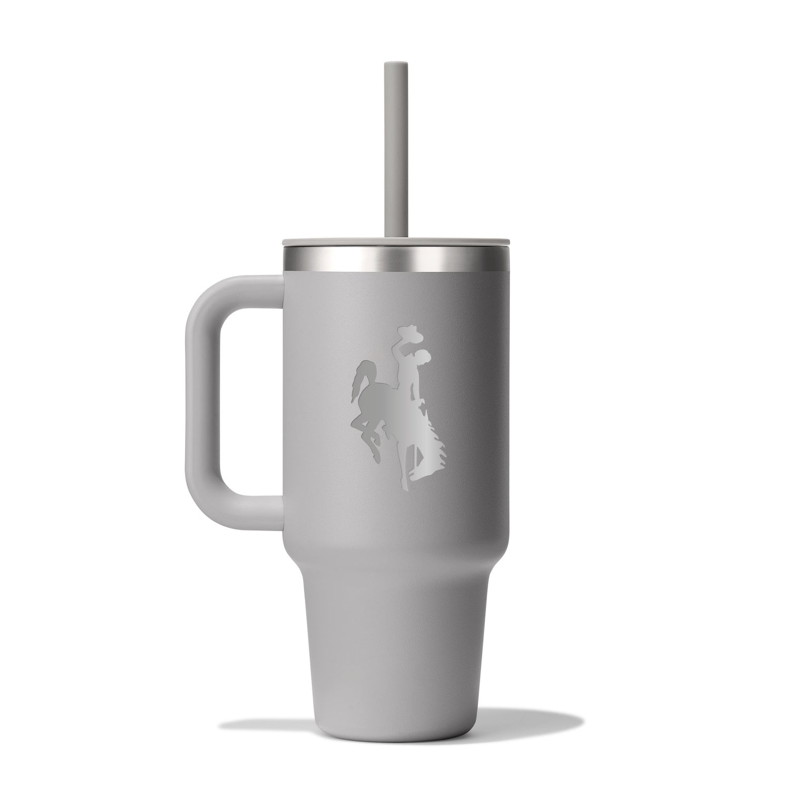 Gray hydro flask tumbler with handle and straw and an etched bucking horse logo on the side pictured on a white background