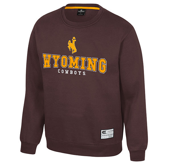A dark brown crewneck sweatshirt featuring 'WYOMING COWBOYS' and a bucking cowboy graphic in gold and white on the chest, shown against a plain white background.