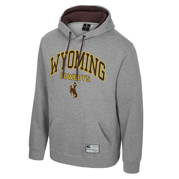 A heather gray pullover hoodie featuring 'WYOMING COWBOYS' printed in gold and brown on the chest, with a cowboy logo underneath. The hoodie has a brown interior hood lining and drawstrings, and a small jock tag near the bottom hem.