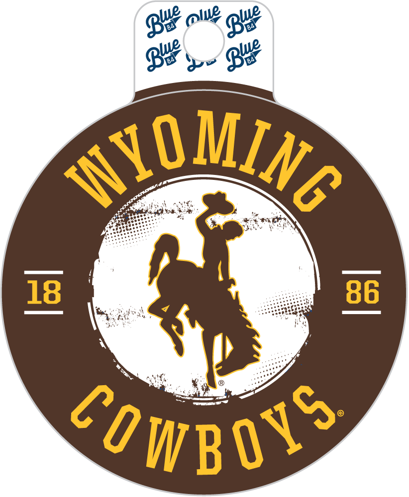 A circular Wyoming Cowboys graphic design with a hanging tab at the top. The design features a brown outer ring, a white center with a cowboy on a bucking horse silhouette, and yellow text reading 'WYOMING COWBOYS' along with '1886'.
