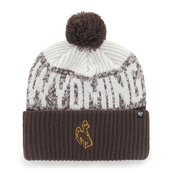 A knit pom-pom beanie hat in white and dark brown with a ribbed brown cuff, featuring a gold embroidered bucking horse logo on the front and a small '47' brand tag on the side.