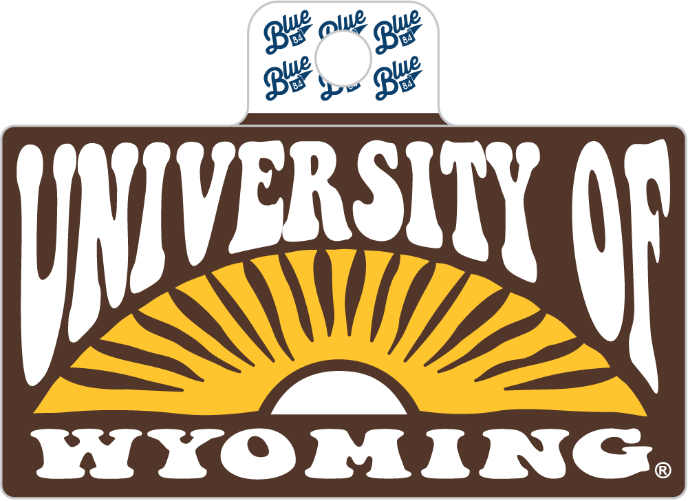 A rectangular University of Wyoming logo sign or sticker with a white hanging tab at the top. The design features the words 'UNIVERSITY OF WYOMING' in large white letters over a yellow sunburst on a dark brown background.