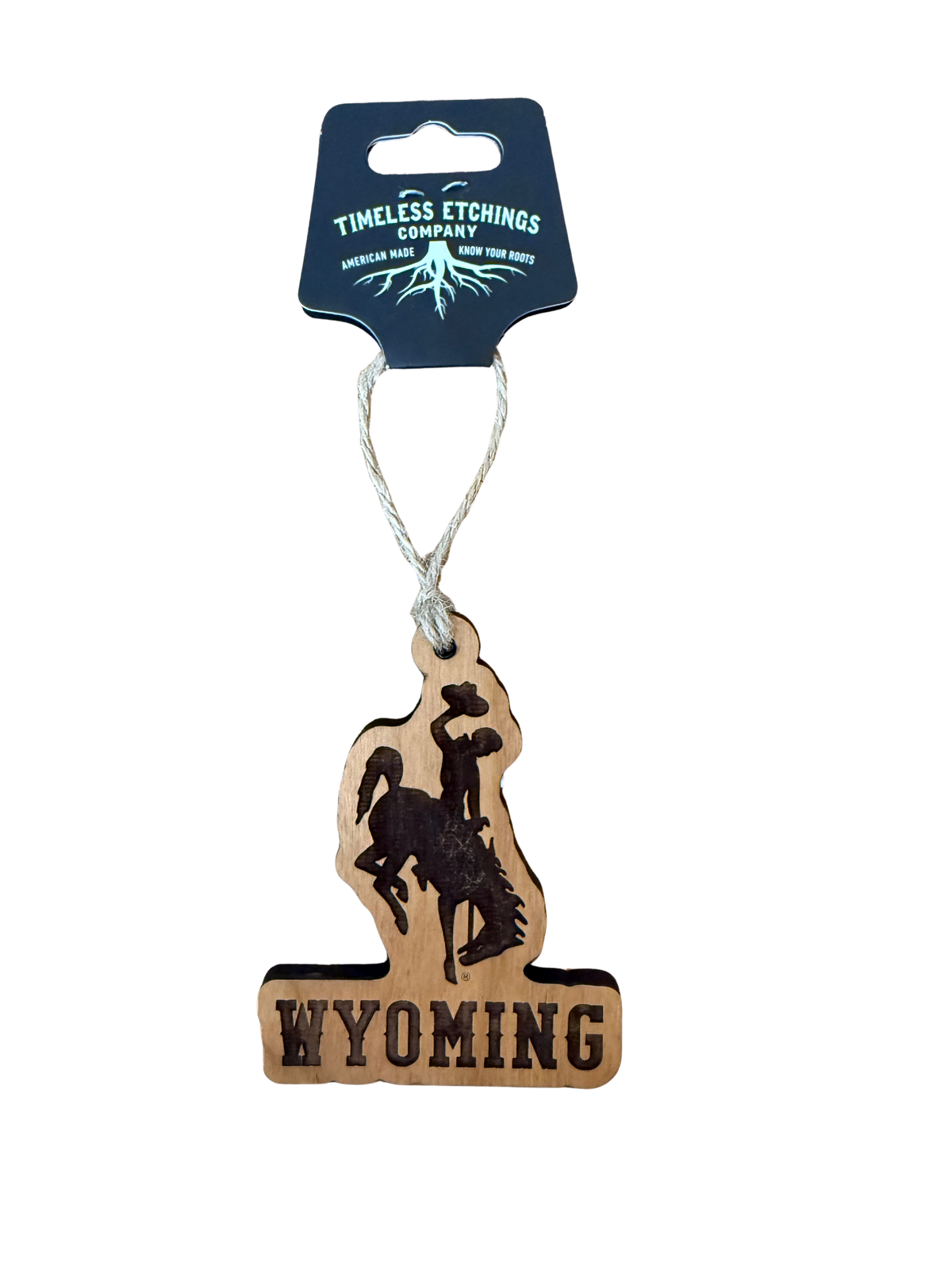 Wooden Ornament with 'Wyoming" and a bucking horse etched hanging from a timeless etching company tag