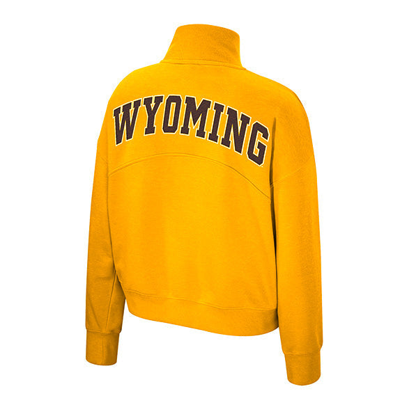 A gold long-sleeve quarter-zip sweatshirt shown from the back, featuring the word 'WYOMING' printed in brown with a white outline across the upper back.