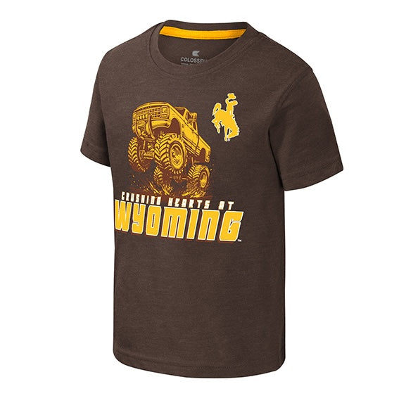 A dark brown short-sleeve t-shirt with a yellow graphic of a monster truck and the text 'Crushing Hearts at Wyoming' along with a cowboy riding a bucking horse, shown on a plain white background.