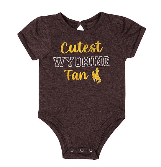 Brown infant onesie with 'cutest wyoming fan' and bucking horse logo on chest. All pictured on a white background.