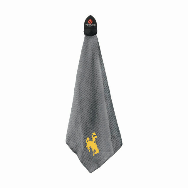 Gray towel with gold bucking horse logo and black magnet at top all on a white background