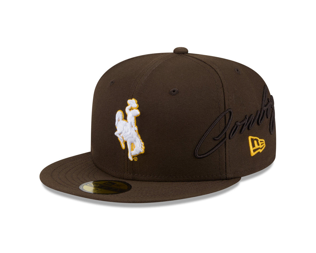 Brown baseball cap with 'bucking horse' logo front and cowboys script embroidered on left side. Pictured on a white background