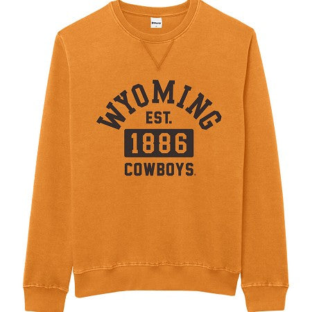 An gold crewneck sweatshirt featuring a distressed brown graphic print on the front that reads 'WYOMING EST. 1886 COWBOYS'.