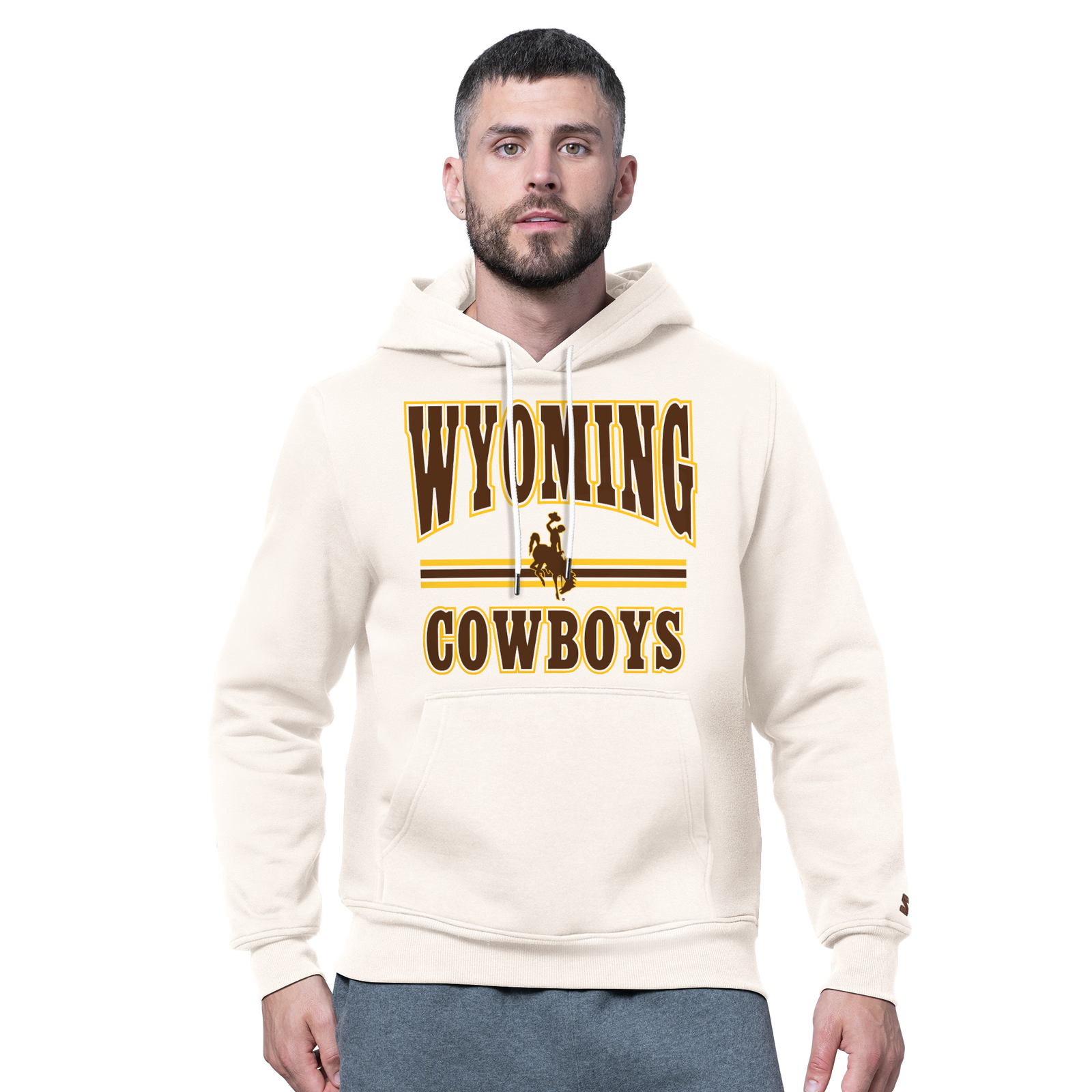 Man modeling a ivory sweatshirt with wyoming cowboys and bucking horse logo on front with kangaroo pocket. Pictured on a white background.