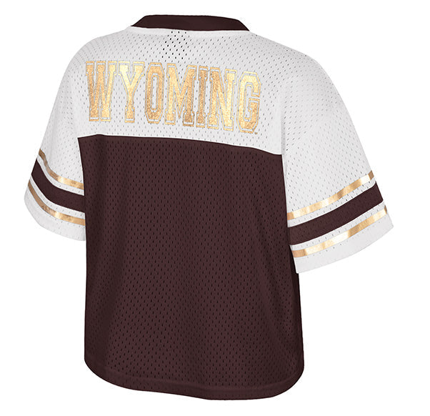 A women's short-sleeve athletic jersey shown from the back, featuring a white mesh upper section with 'WYOMING' in metallic gold lettering, a solid dark brown lower body, and gold and brown stripes on the sleeves.