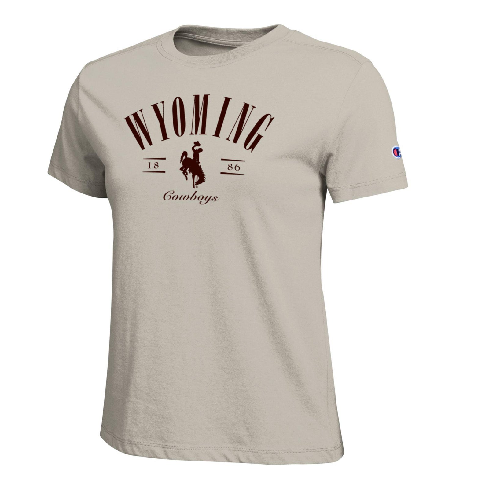 A light beige t-shirt featuring a dark brown graphic on the front that reads 'WYOMING Cowboys' with  a bucking horse logo center chest, and a small Champion logo on the left sleeve.