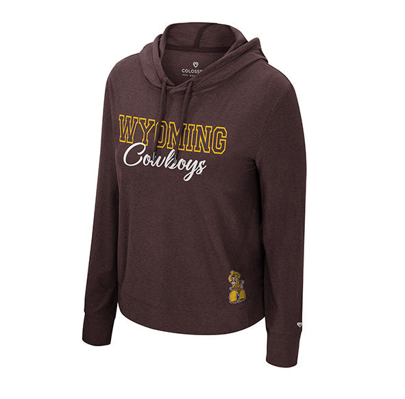 A dark brown long-sleeve hoodie featuring 'WYOMING Cowboys' printed on the chest in gold and white, with a small cowboy logo near the lower left hem, shown against a plain white background.