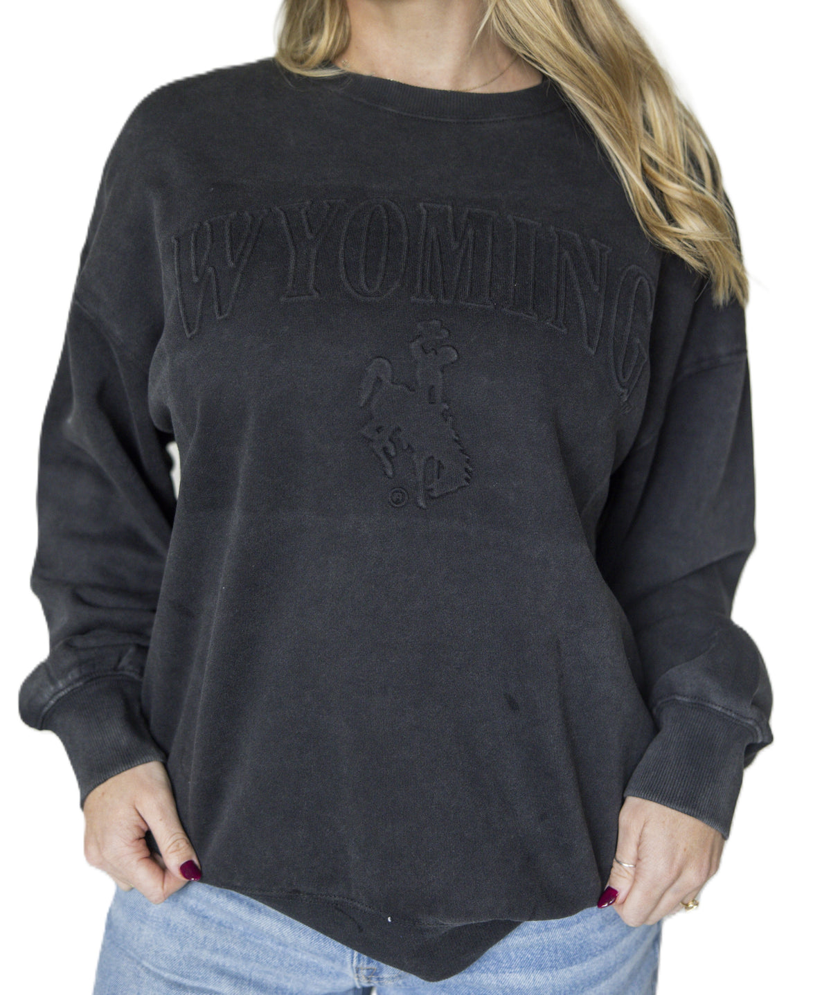 Black crewneck with wyoming and bucking horse logo embroidered on front. Pictured on a white background and woman wearing the crew.