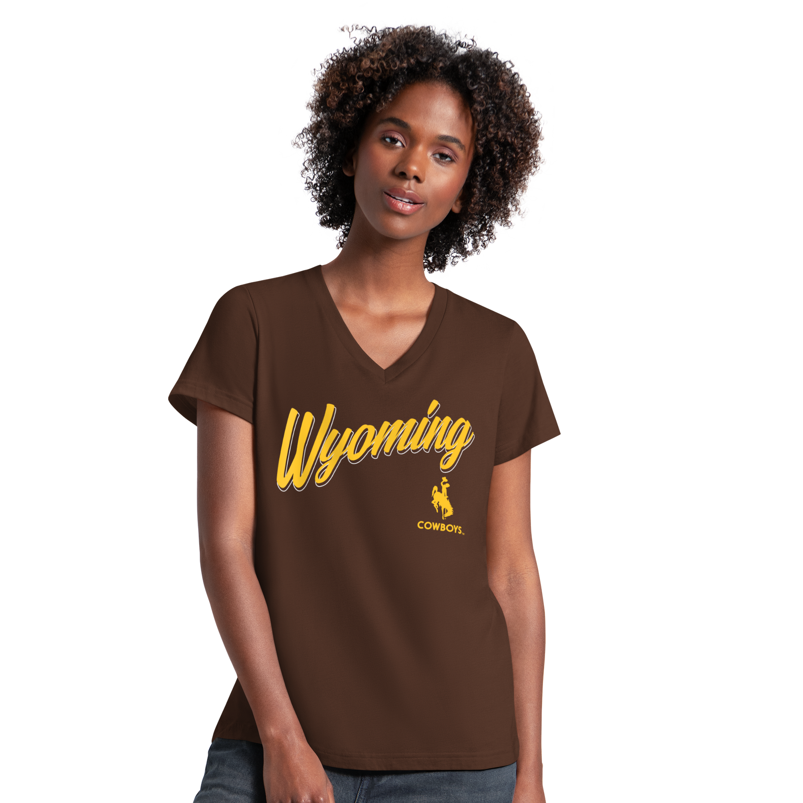 Woman with dark curly hair posing with a brown tee shirt on that says 'wyoming cowboys' in gold with bucking horse logo. 