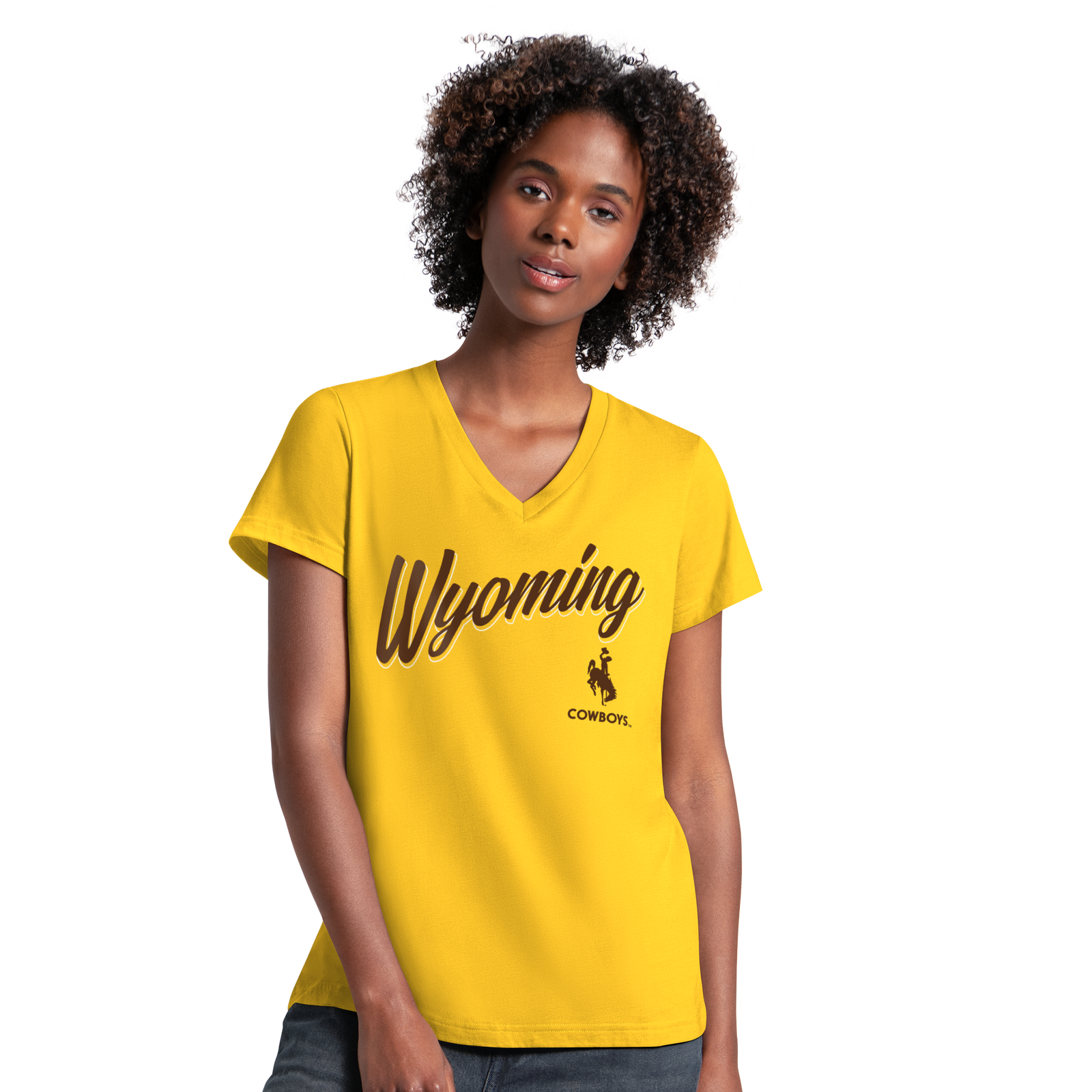 A woman with curly dark hair wearing a bright yellow V-neck t-shirt with 'Wyoming COWBOYS' printed in brown across the chest with bucking horse, posed against a solid white background.