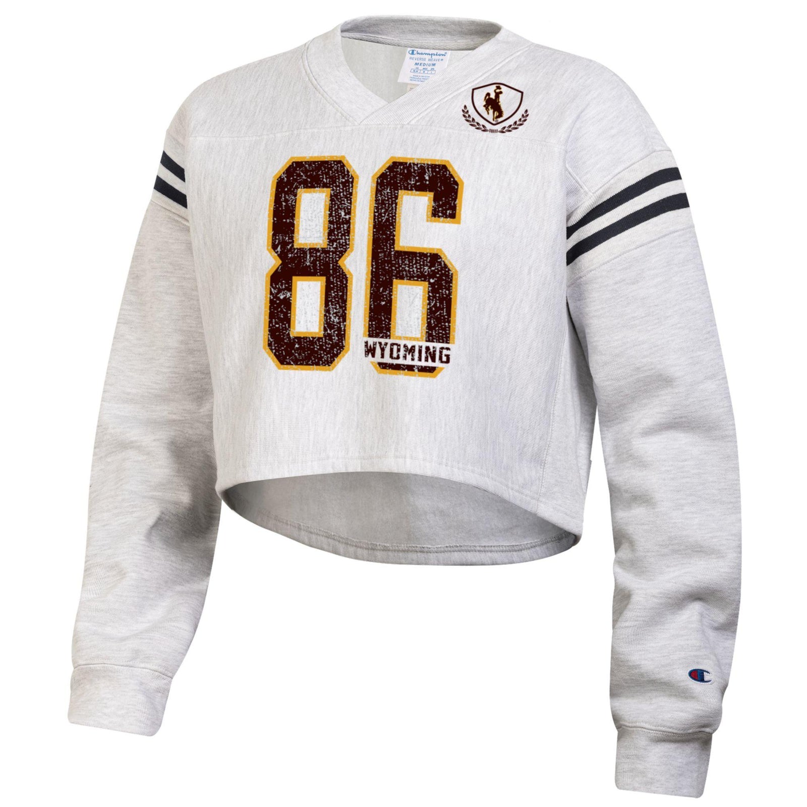 women's cropped crew with brown 86 with gold outline centered. wyoming lettering in the 6. top left chest has a bucking horse and both shoulders have two lines