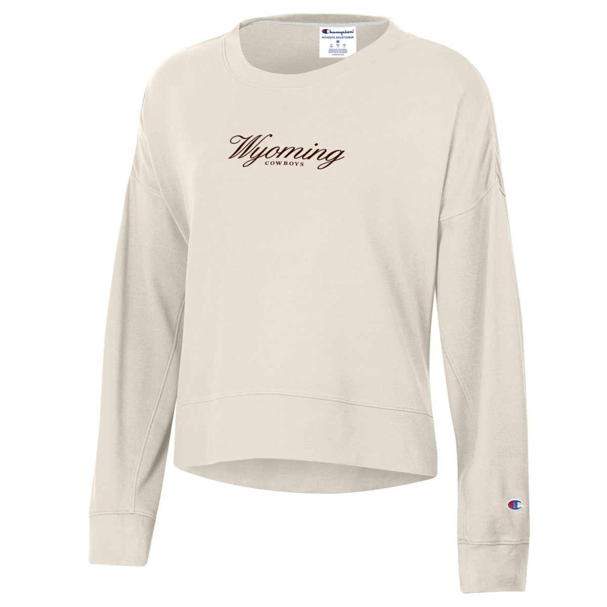 ivory women's champion crewneck with small brown design center chest. design is script wyoming with cowboys lettering below