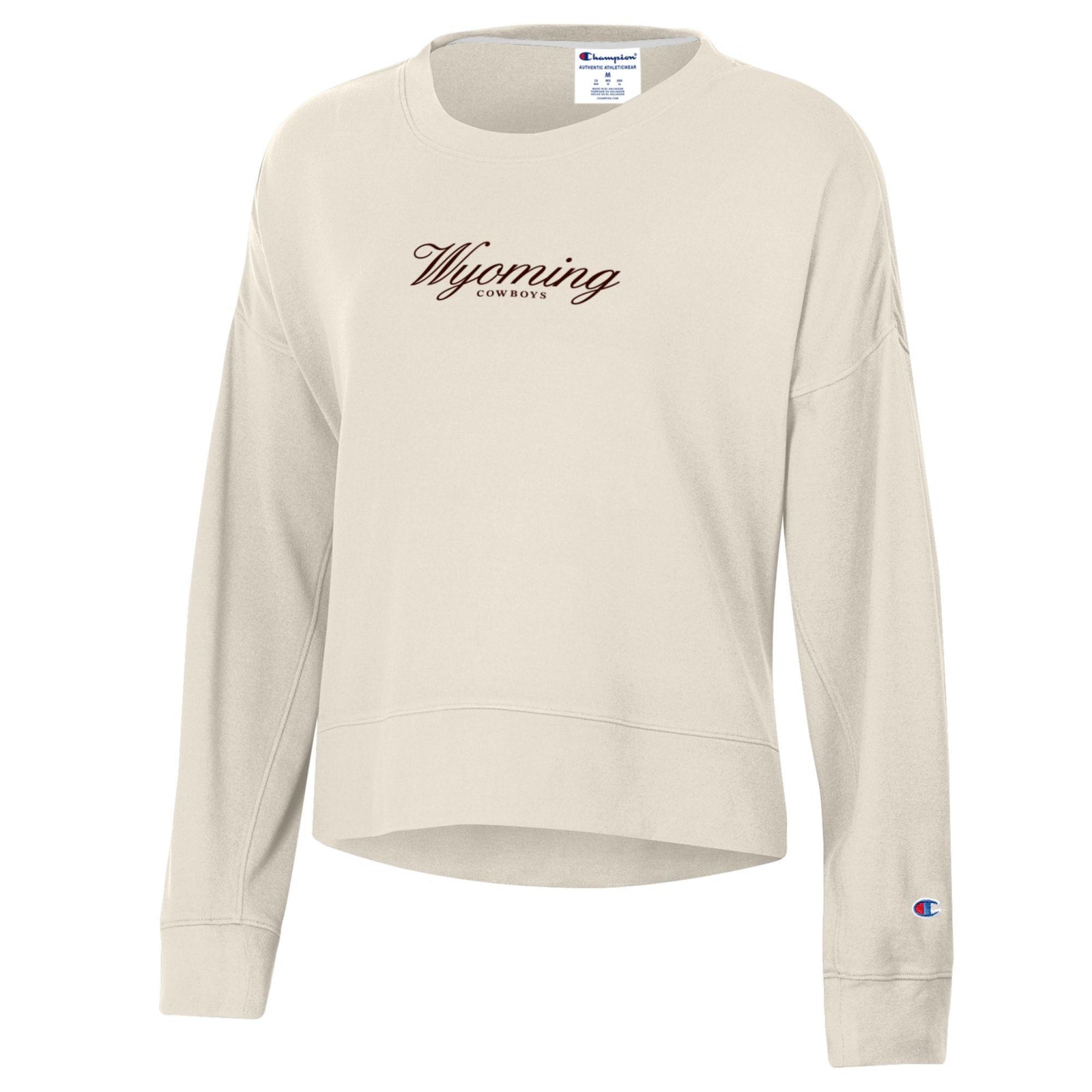 ivory women's champion crewneck with small brown design center chest. design is script wyoming with cowboys lettering below