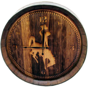 circular wooden clock made out of wine barrel pieces with a large etched bucking horse in the center with etched clock numbers