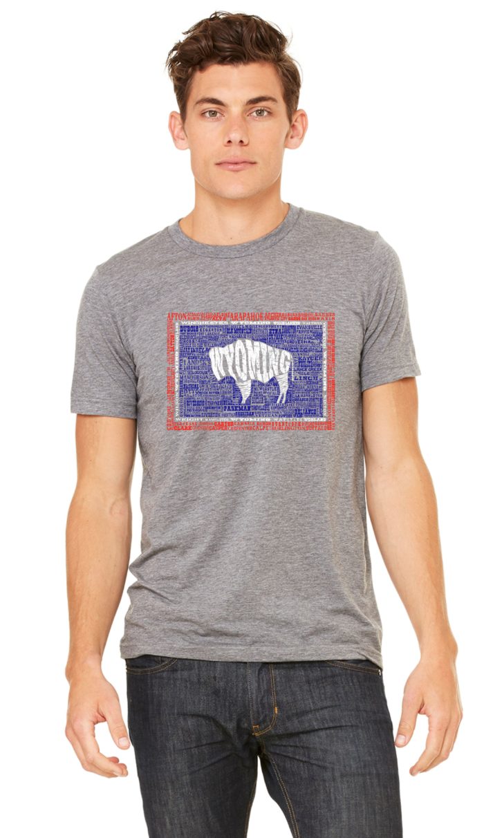 grey short sleeved tee with design on front. Design is all the towns of Wyoming printed in red, navy, and white that form an image of the Wyoming flag