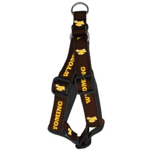 nylon brown dog harness with black stitching and hardware. Repeated Wyoming and bucking horse design printed in gold around the harness