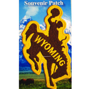 bucking horse shaped iron on patch. patch is brown with gold outline, with word Wyoming inside the bucking horse in gold
