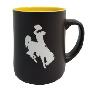 brown mug with gold colored interior. Large white bucking horse printed on one side and word Wyoming printed on the other