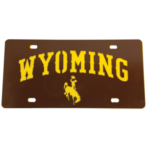 2 piece license plate cover with gold background piece and metal brown top piece. top metal piece with word Wyoming and bucking horse cut out