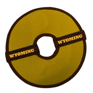 gold fabric disk, dog toy. trimmed in brown, with word Wyoming printed on either side of the disk. hole in the middle of disk