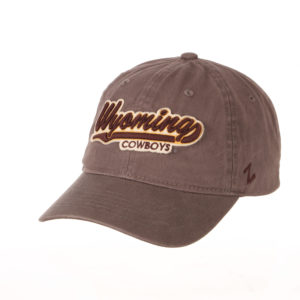 grey, unstructured adjustable hat. Word Wyoming appliquéd in brown and white script font on front of hat, word Cowboys embroidered smaller below