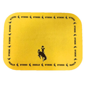17inches long and 12 inched wide gold, pet placemat. word Wyoming and bucking horse in brown, printed along the border of placemat