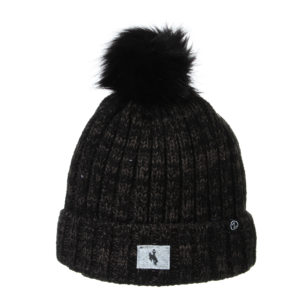 black knit beanie, fleece lined. black faux fur pom on top of beanie. grey fabric patch with small bucking horse on it, sewn on front cuff of beanie