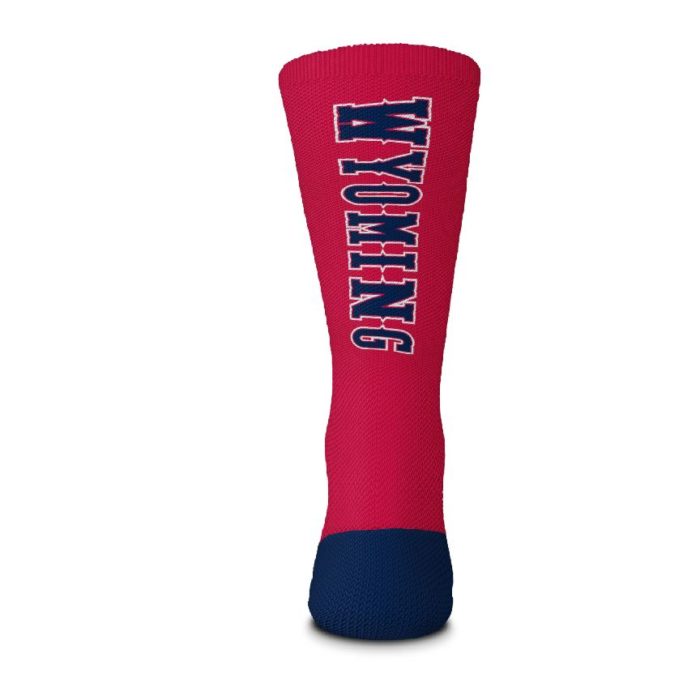 back view of red crew length sock. Word Wyoming printed in blue with white outline, vertically down the back of the sock