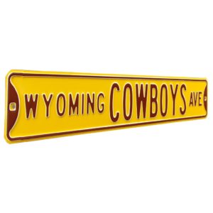 gold, metal street sign with the slogan Wyoming Cowboys Ave printed in block brown letters on street sign. has brown trim