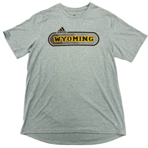 moisture wicking, grey short sleeved tee. Word Wyoming printed in gold inside of rectangular, brown oval on front of tee