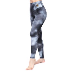 women's black and white tie die leggings. small brown bucking horse logo with gold outline printed on left side of waist band